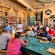 A guide giving a presentation to a tour group inside a rustic coffee shop
